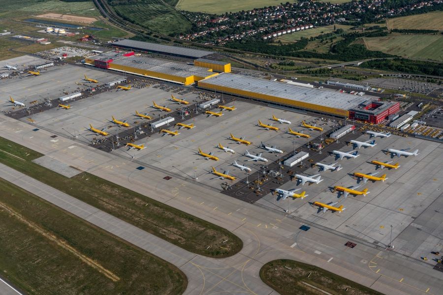 Leipzig Schkeuditz, Germany, June 2021 DHL cargo hub with main cargo apron, main buildings and hangar and many cargo airplanes parked on apron - aerial view