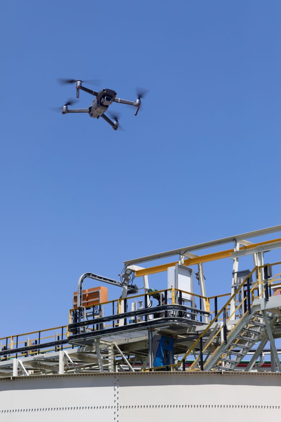 UAV drone doing an inspection, exploring industrial structure , gas pipelines on mining operations , with RTK module